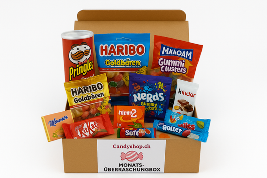 Bunte Auswahl an Süßigkeiten in einer neutralen Box, inklusive Schokolade und Bonbons.