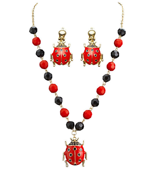 Schmuckset mit Marienkäfer-Kette und passenden Ohrringen auf weißem Hintergrund