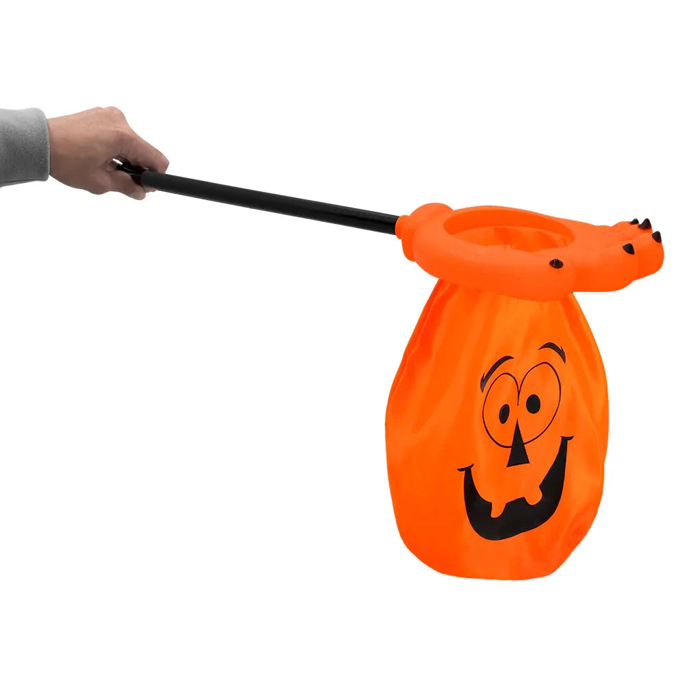 Orange pumpkin trick-or-treat bag with grinning face, wooden handle and stick, 26 cm.