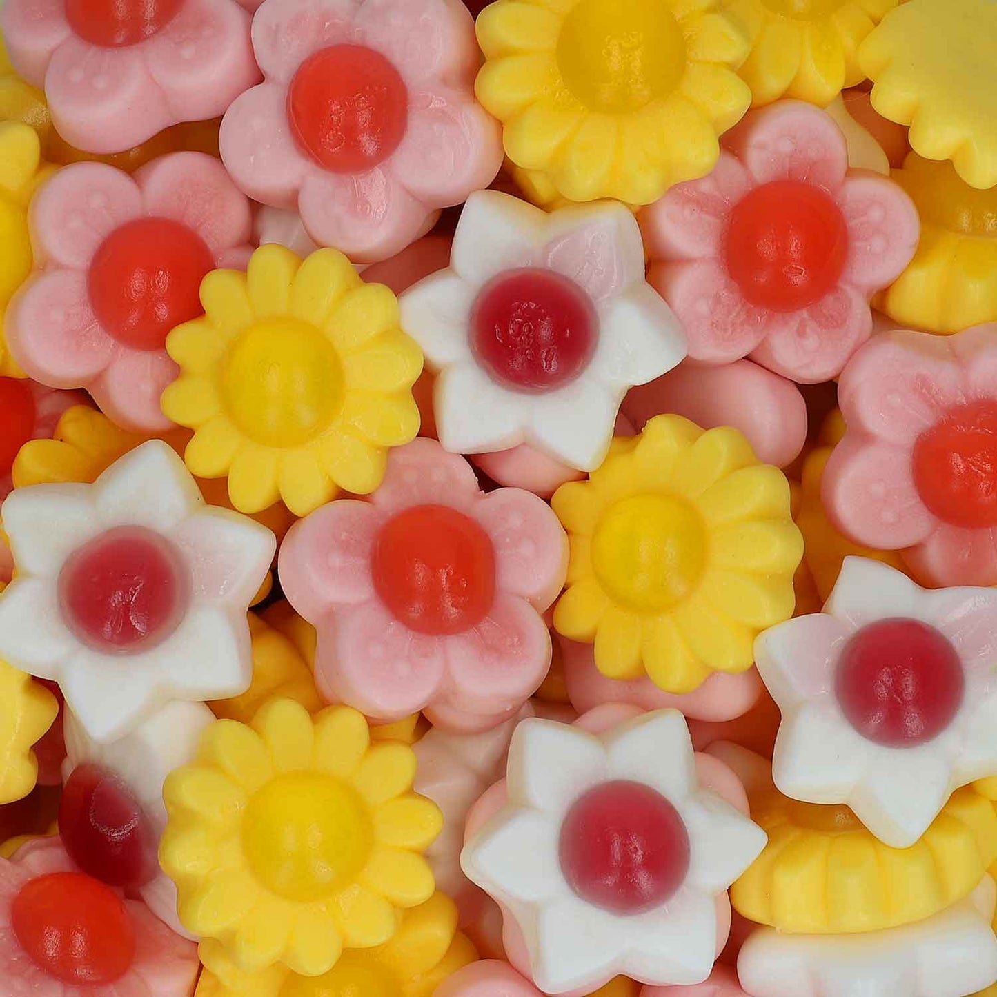 Bunte, blumenförmige Fruchtgummis mit fondantfüllung in fünf Geschmacksrichtungen.
