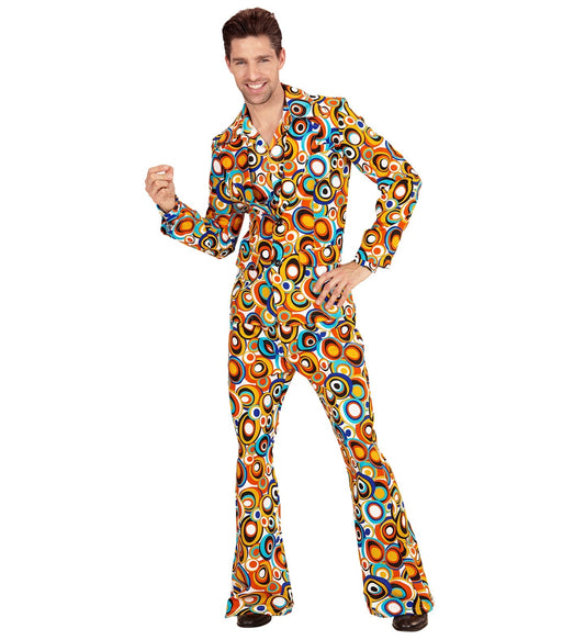 Man modeling a colorful 70s disco suit with bubble pattern, flared trousers, and open jacket.