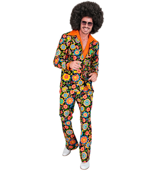 Man in colorful floral 70s suit with orange collar and wide lapels, posing dynamically.
