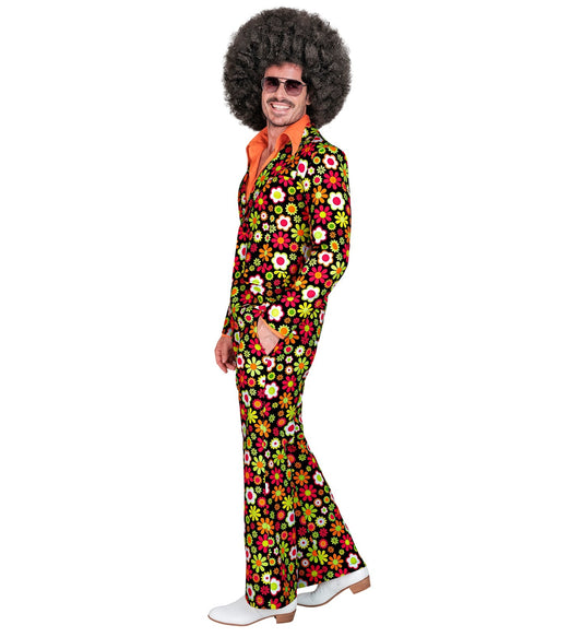 Man in 70s retro disco costume with afro wig, floral suit, and bell-bottom pants.