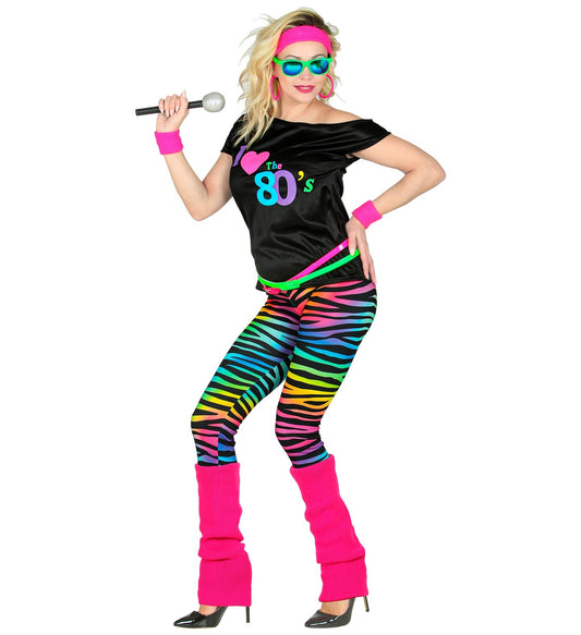 Woman in 80s neon outfit with black sleeveless shirt, rainbow zebra leggings, pink leg warmers, headband, wristbands, and microphone.