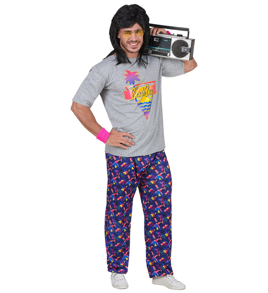 Man in 80s beach boy costume with retro palm print shirt, patterned pants, boombox, and sunglasses.