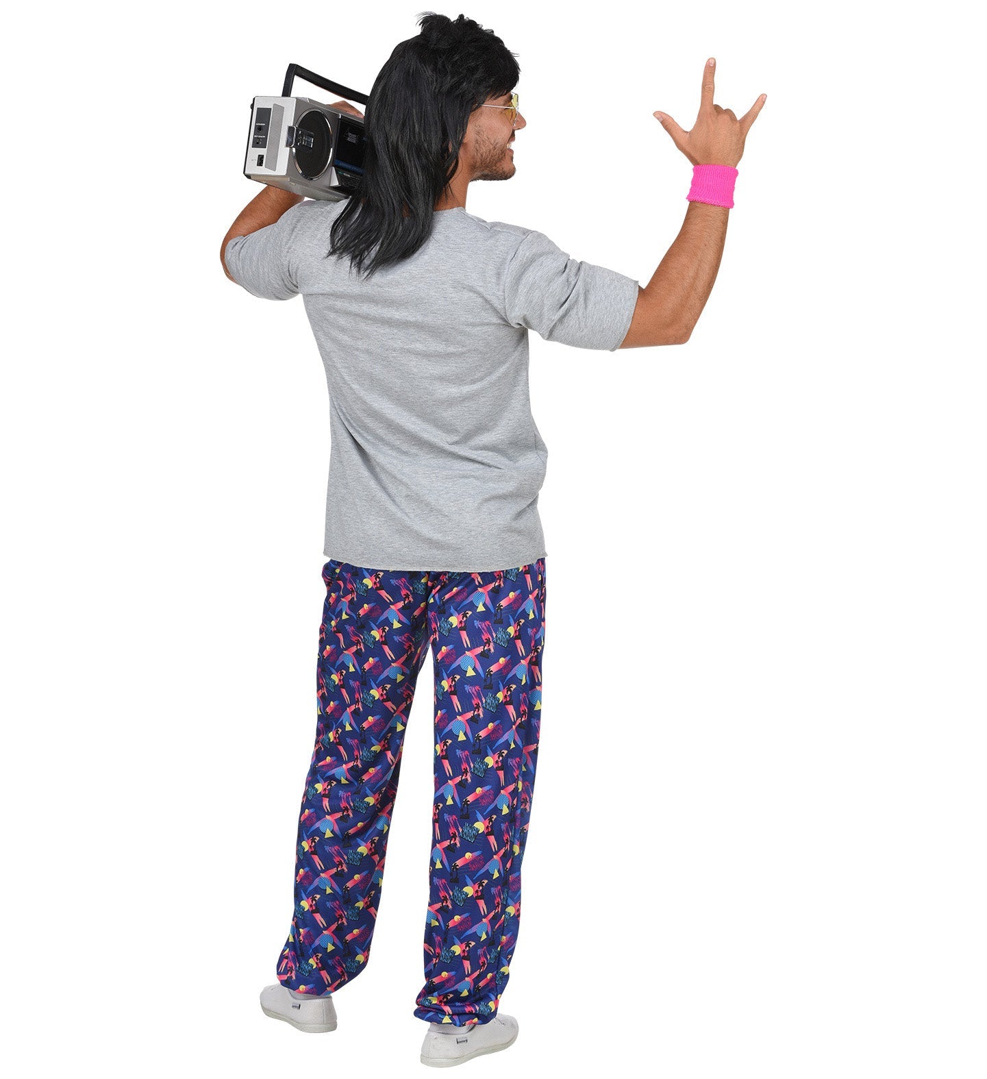 Rear view of man in 80s beach boy costume with gray shirt, colorful palm print pants, boombox, and wristband.