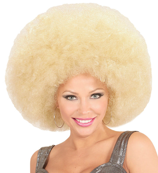 A woman models a giant blonde afro wig with large curls over a white background.