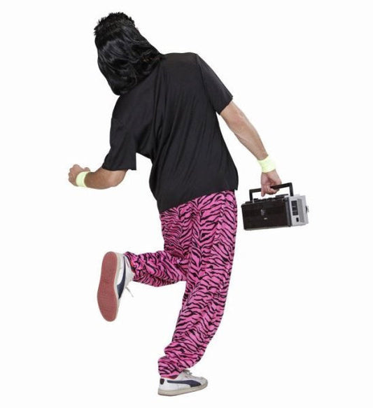 Man in 80s Love Boy costume with black wig, graphic T-shirt, pink zebra pants, neon wristbands, and boombox.