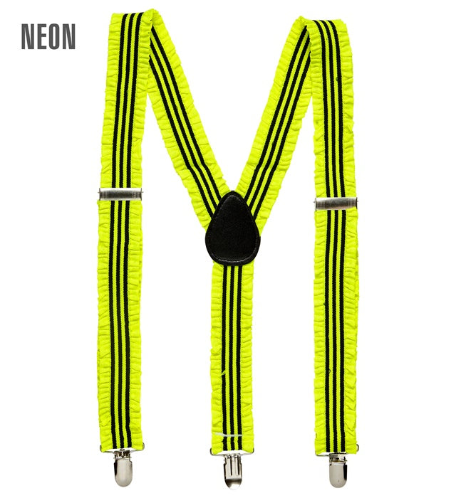 Neon gelbe Hosenträger mit Rüschen auf weißem Hintergrund