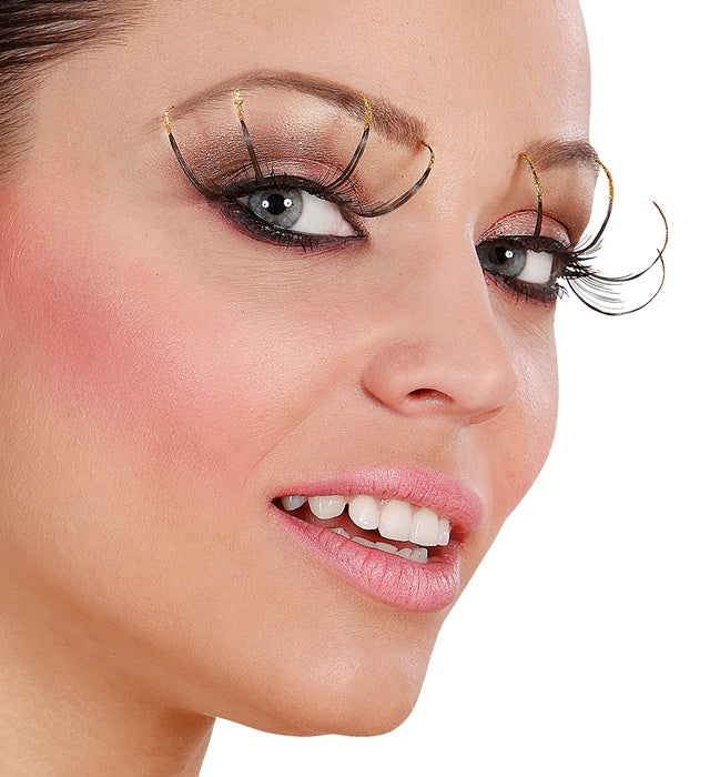 Schwarze lange Wimpern mit goldfarbenem Rand und Klebstofftube