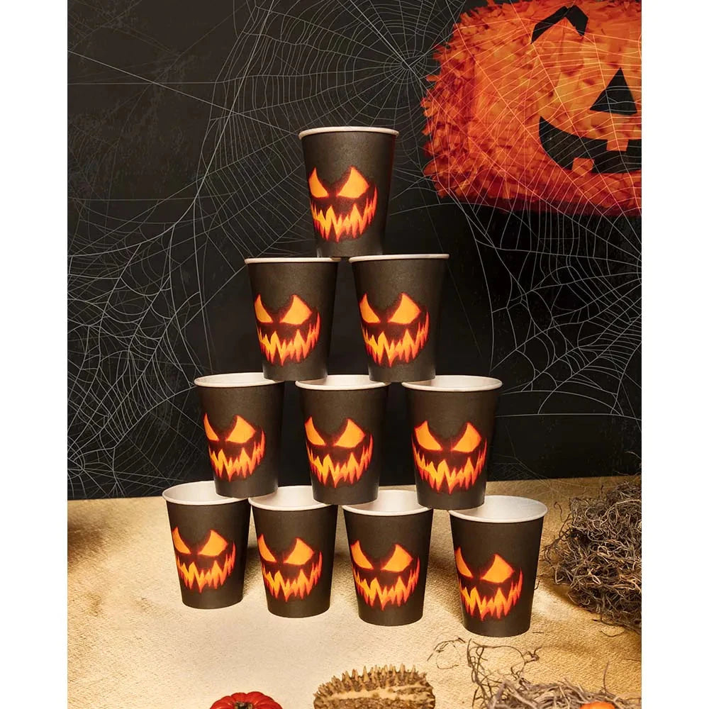Stack of 10 black disposable paper cups with creepy orange pumpkin faces for Halloween parties.