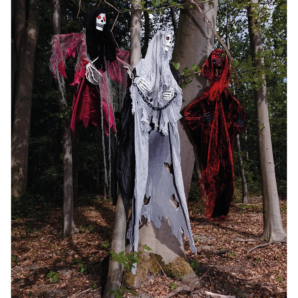 Animated Grim Reaper hanging decoration with motion-sensor LED eyes on a tree.