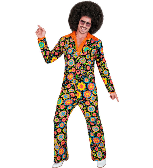 Man in 70s floral suit with afro wig, sunglasses, and platform shoes dancing.
