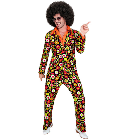Man in 70s retro disco costume with afro wig, floral suit, and pointing pose.
