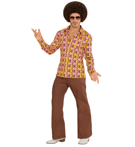 Man in afro wig and sunglasses wearing a colorful 70s disco shirt with bell-bottom pants.