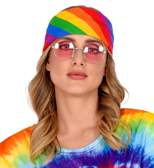 A colorful rainbow cotton bandana tied as a headscarf on a model with blonde hair and pink-tinted glasses.