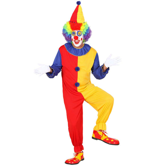 Man in colorful clown costume with red, blue, yellow jumpsuit, pom-pom hat, and red shoes.