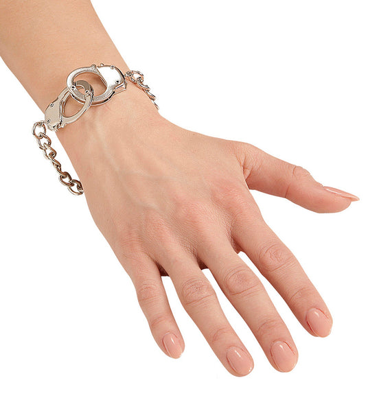 Matte silver metal handcuff-style cuff bracelet on a woman's wrist.