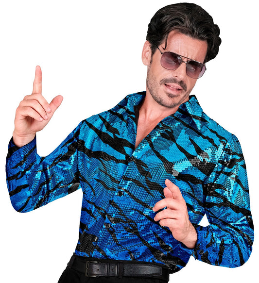 Man in blue and silver sequin zebra print shirt posing dynamically.
