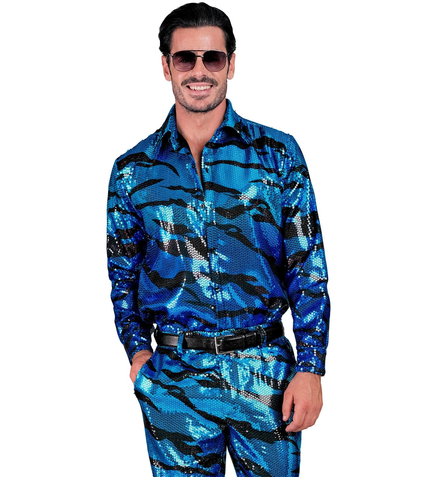 Man in blue and silver sequin zebra print shirt, smiling with hands in pockets.