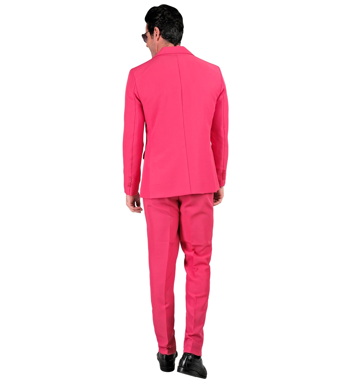 Rear view of a man wearing a neon pink slim-fit suit with black shoes.