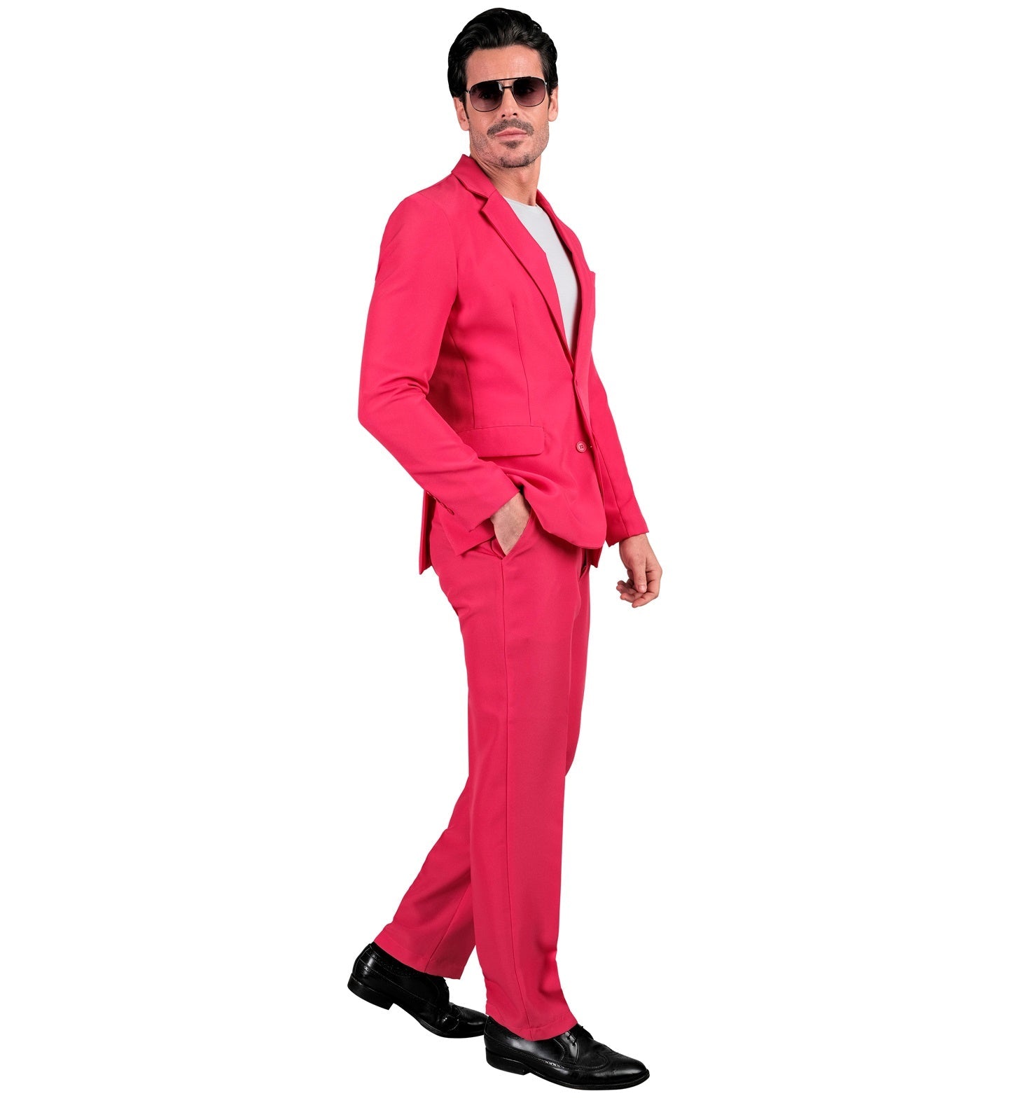 Man in neon pink slim-fit suit with white shirt and black shoes, side view.