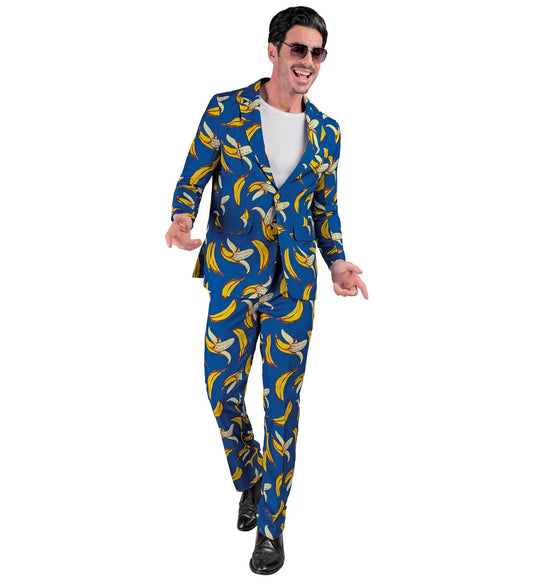 Man in blue Opposuits suit with neon banana pattern, smiling and posing.