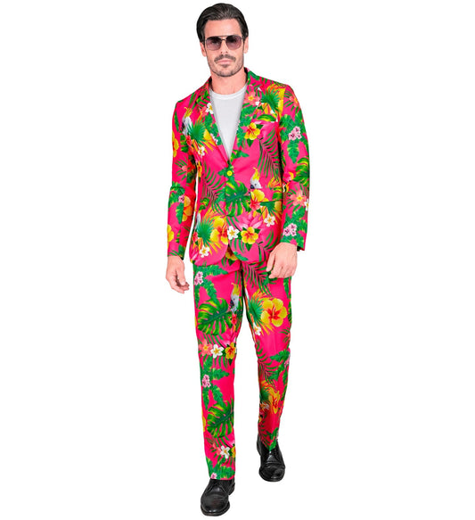 Man in neon Hawaiian print suit with pink, green, and yellow floral pattern.