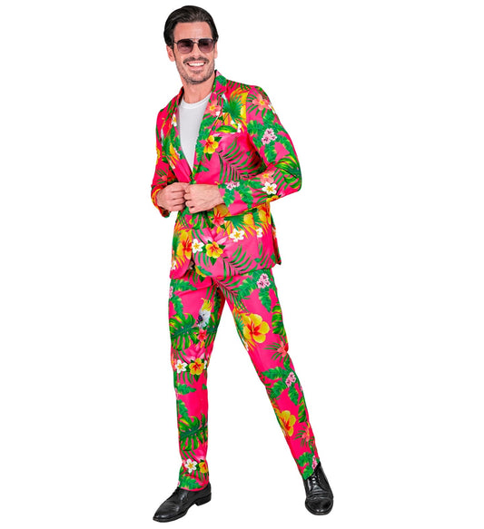 Man in neon Hawaiian floral print suit with pink and green hibiscus pattern.