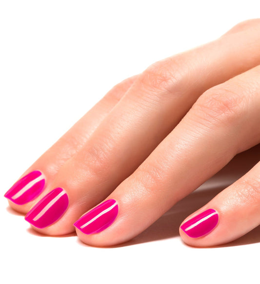 Close-up of hands with glossy neon pink peel-off nail polish applied to fingernails.