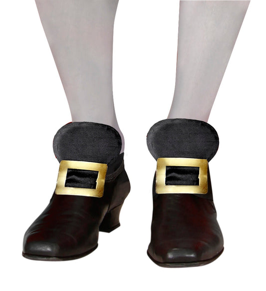 Pair of gold metal shoe buckles with black straps on loafers.