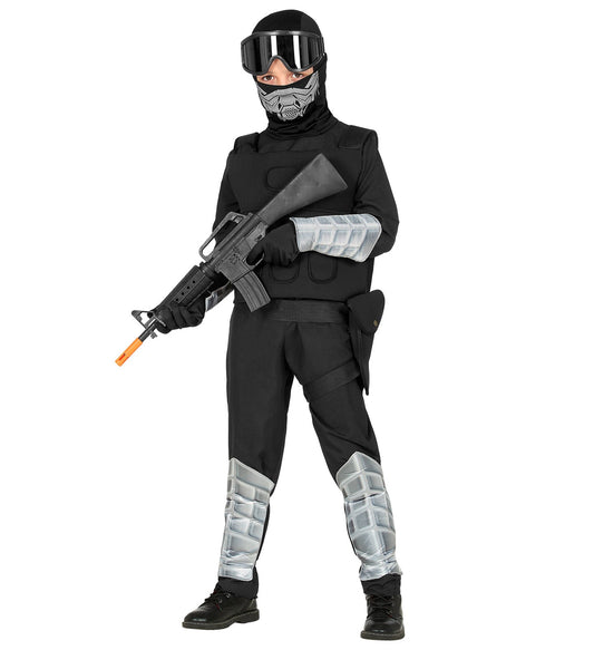 Child in black Special Forces tactical uniform with mask, goggles, vest, arm guards, and toy rifle.