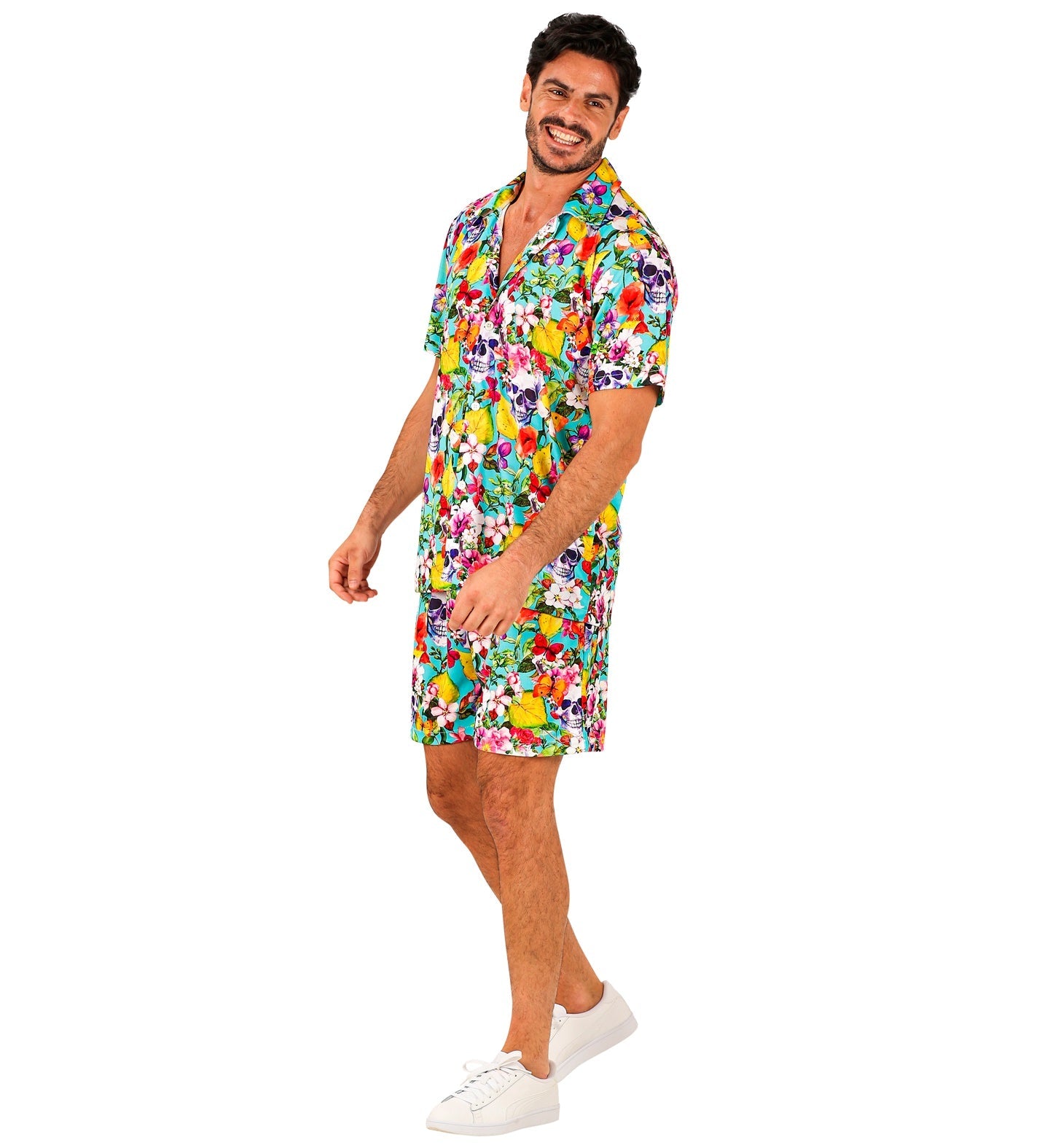 Man in colorful Hawaiian shirt and shorts with skull prints, side view.