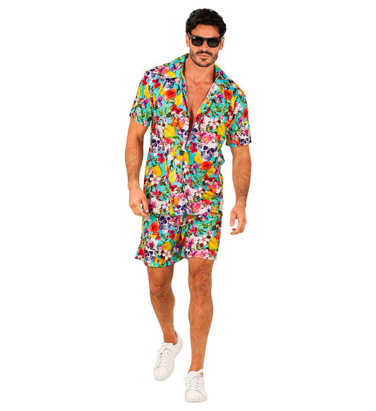 Man in colorful Hawaiian shirt and shorts with skull print, wearing sunglasses and white sneakers.