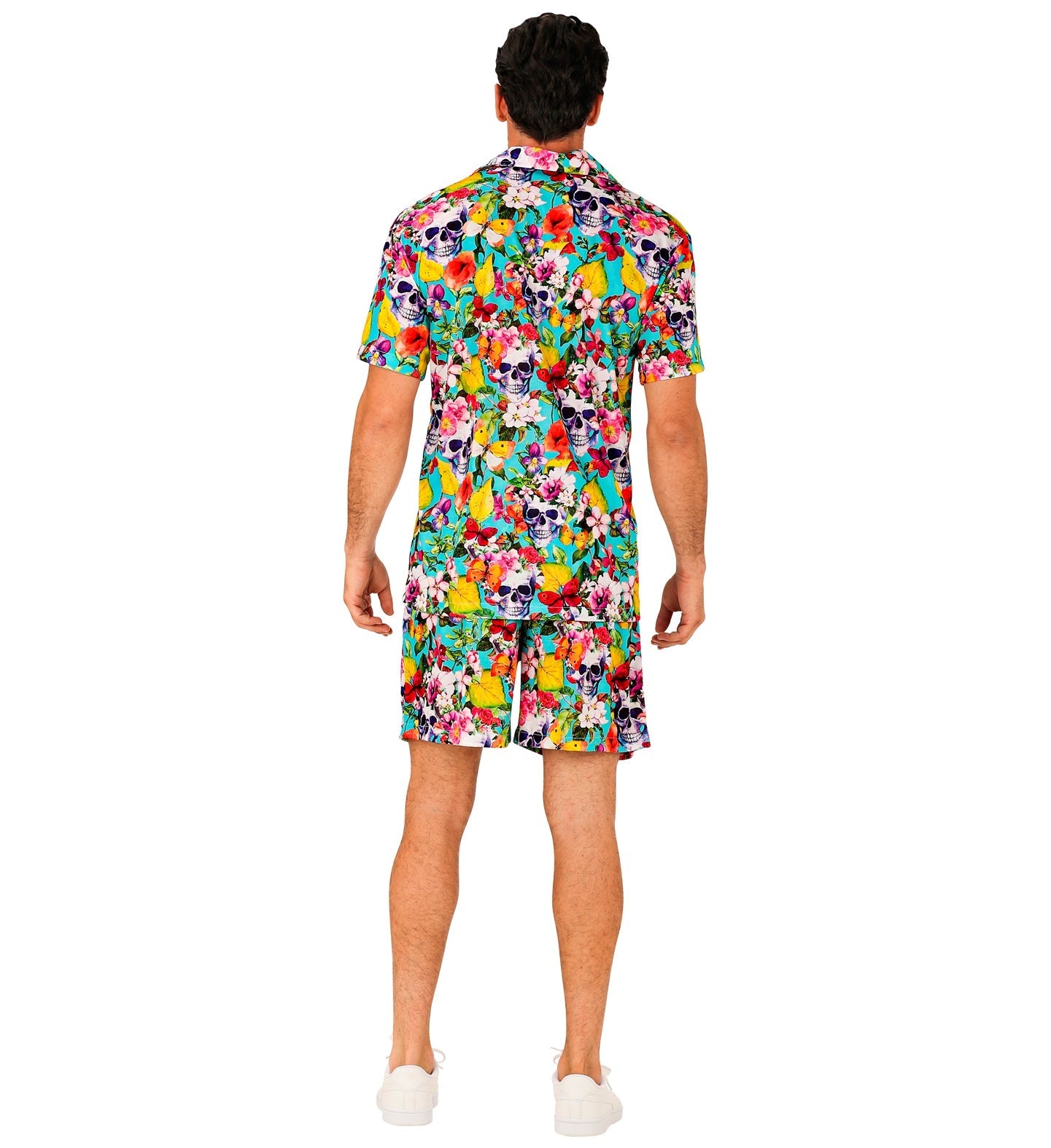 Rear view of man wearing colorful Hawaiian shirt and shorts with skull prints.